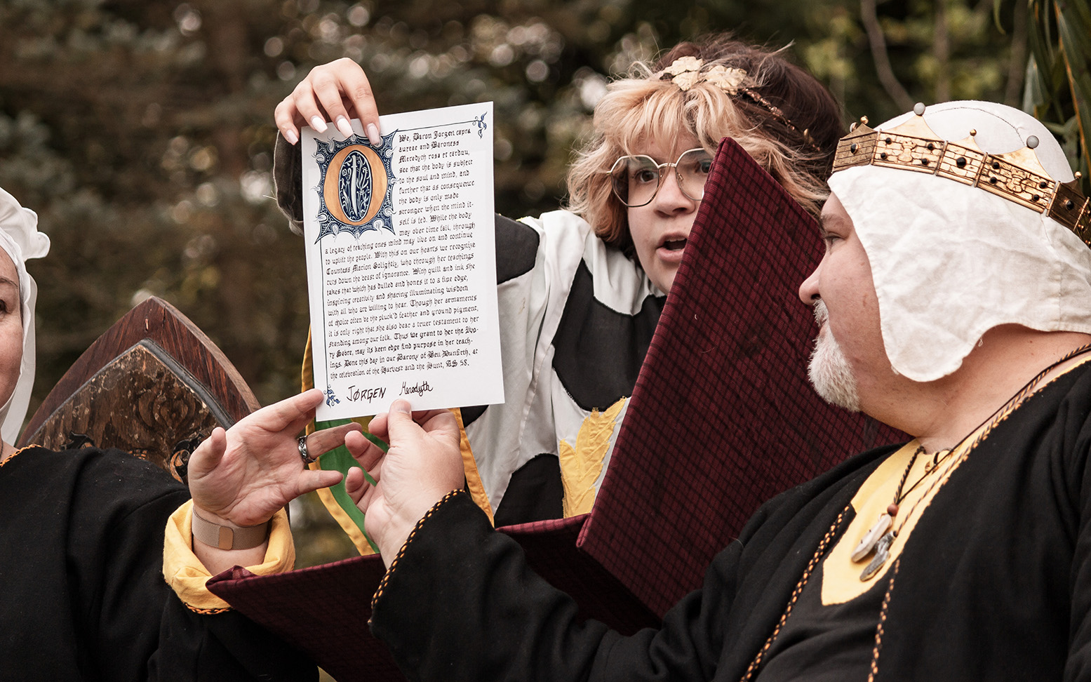 Lady Mabel Juniper reads out a scroll during evening court