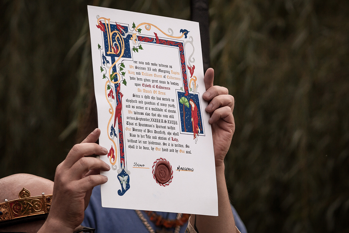 Hands holding a decorative scroll with a red seal