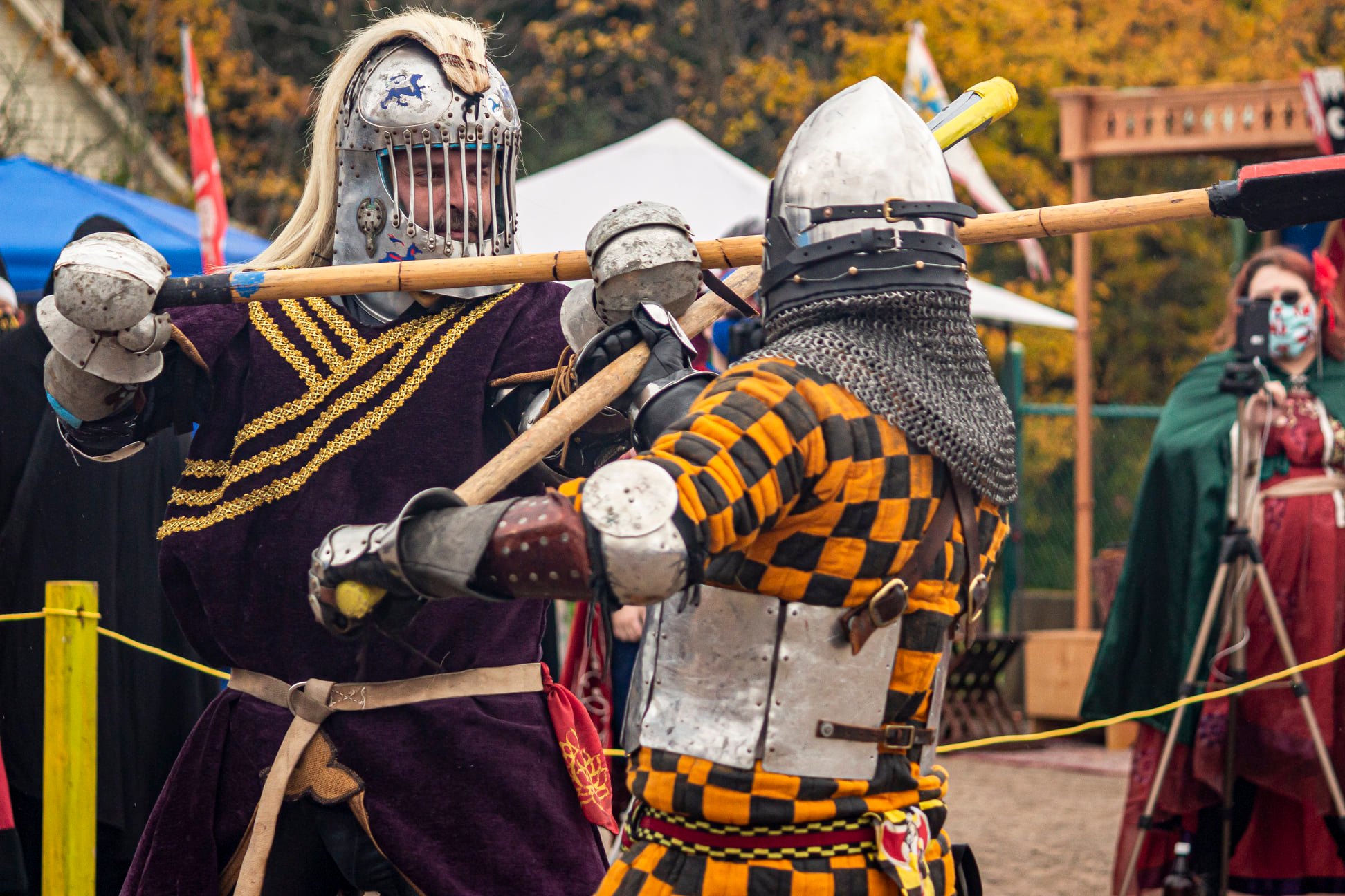 Rozakii fighters stand in a line, holding shields and spears